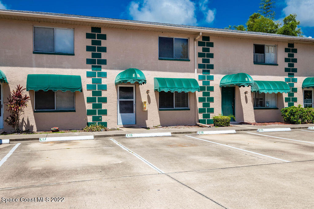 1880 Murrell Road, Unit 18 Rockledge, FL 32955 - Photo 2 of 26 a couple of palm trees in front of house