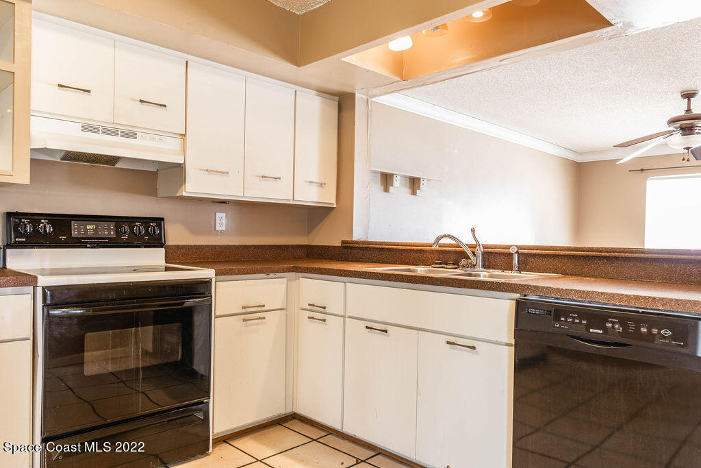 1880 Murrell Road, Unit 18 Rockledge, FL 32955 - Photo 9 of 26 a kitchen with white cabinets and appliances
