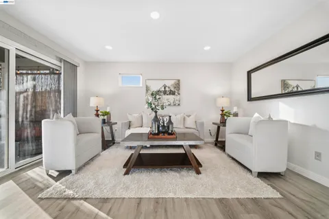 a living room with furniture a rug and a window