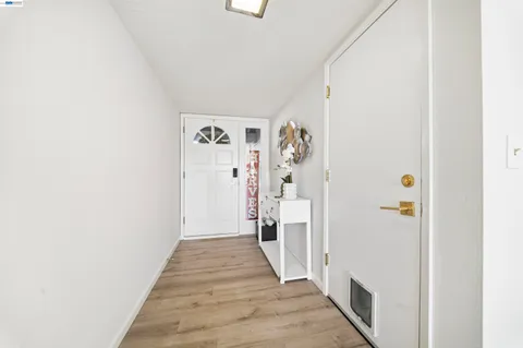 a living room with furniture and floor to ceiling window