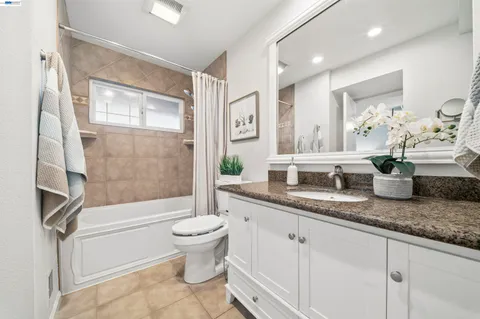 an empty room with a ceiling fan and a window