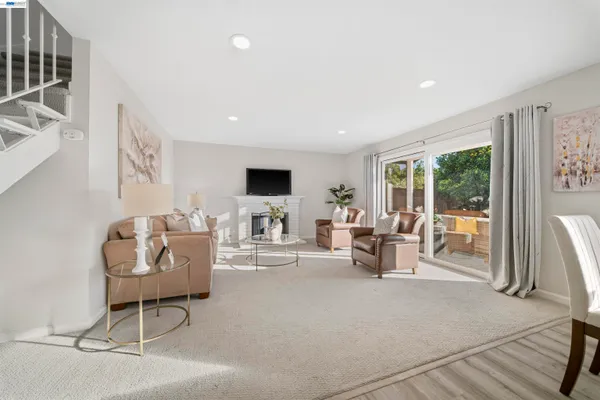 a living room with furniture a fireplace and a flat screen tv
