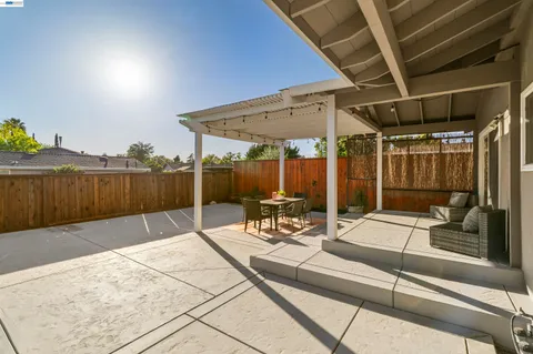 a view of a patio with a table and chairs