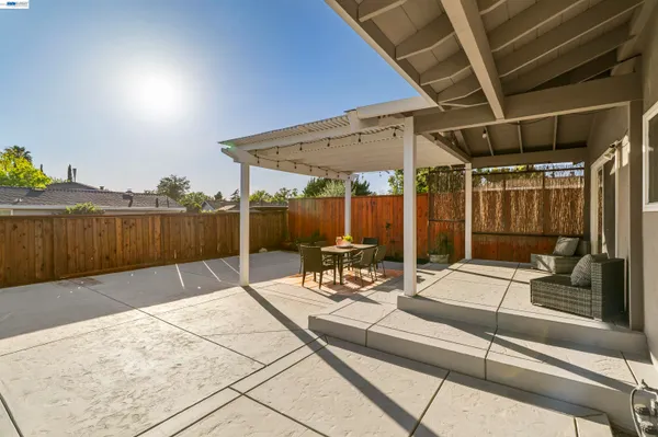 a view of a patio with a table and chairs