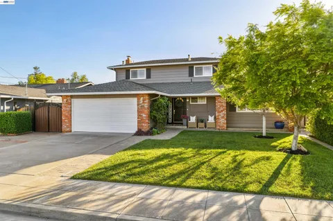 a front view of a house with a yard and a garage