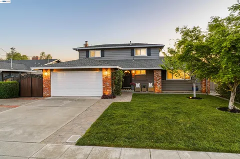 a backyard of a house with yard and outdoor seating