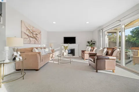 a kitchen with white cabinets and window