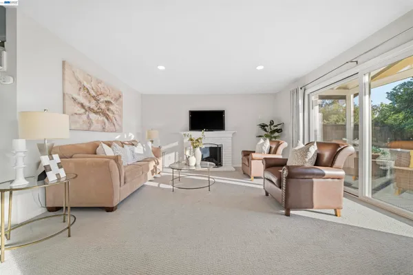a kitchen with white cabinets and window