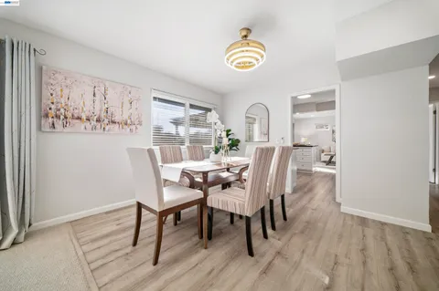 a kitchen with a sink cabinets and wooden floor