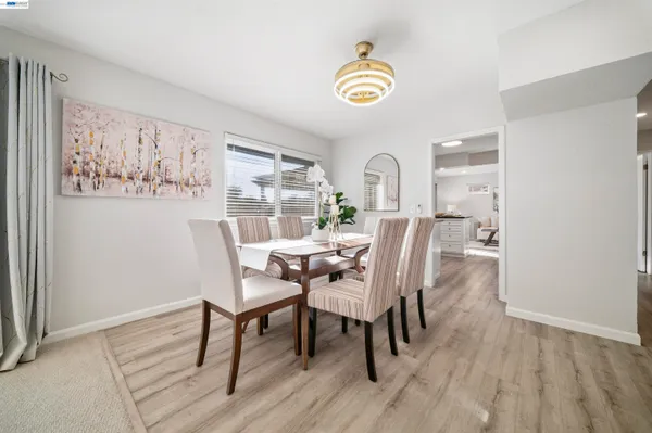 a kitchen with a sink cabinets and wooden floor