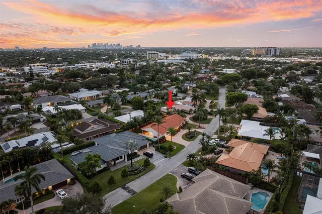 an aerial view of a city with lots of residential buildings and mountain view in back