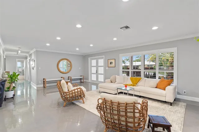 a living room with furniture and large window