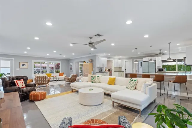 a kitchen with stainless steel appliances kitchen island granite countertop a table and chairs in it
