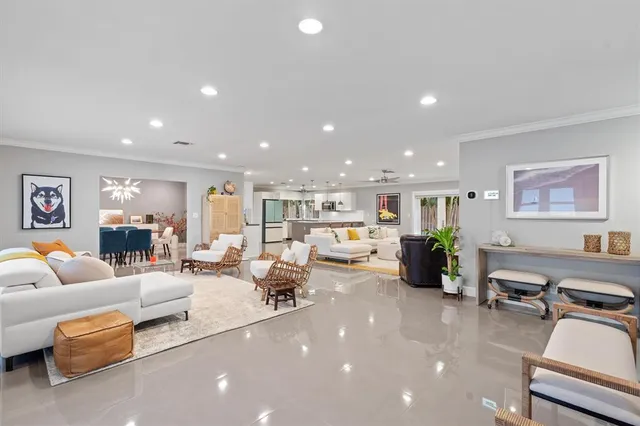 a living room with furniture and a chandelier