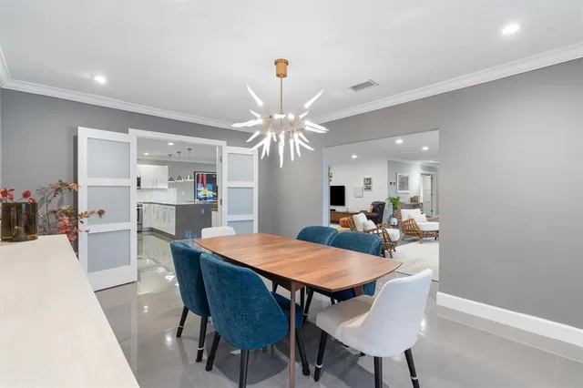 a spacious bedroom with a bed a couch and a potted plant on the counter