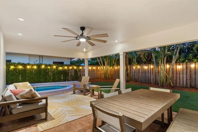 a living room with furniture a projector and pool table