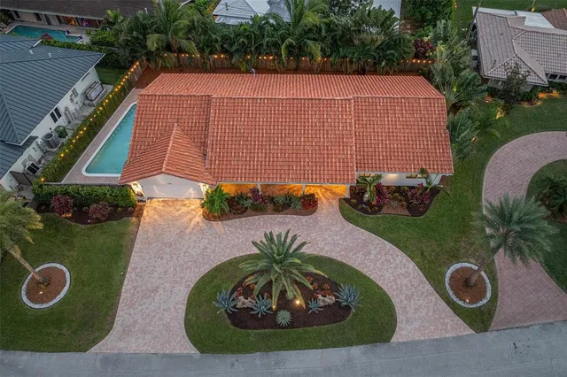 an aerial view of a house with garden space and street view