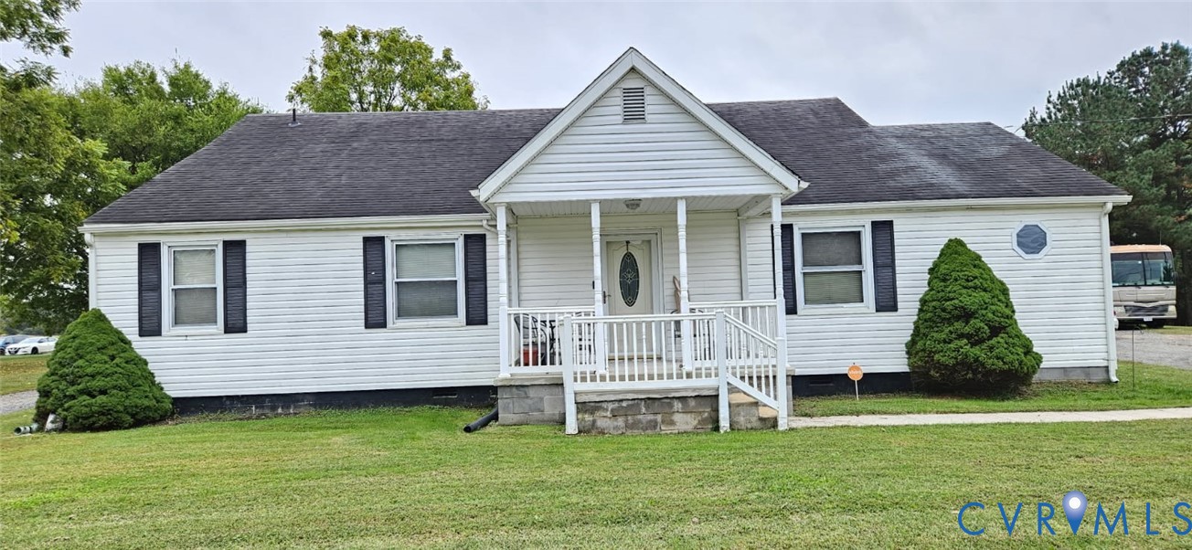 1025 Sunnyside Road Tappahannock, VA 22560 - Photo 1 of 6 a view of a house with a yard