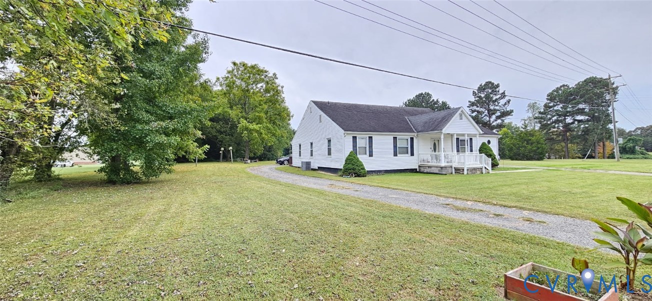 1025 Sunnyside Road Tappahannock, VA 22560 - Photo 3 of 6 a view of an house with backyard and a tree