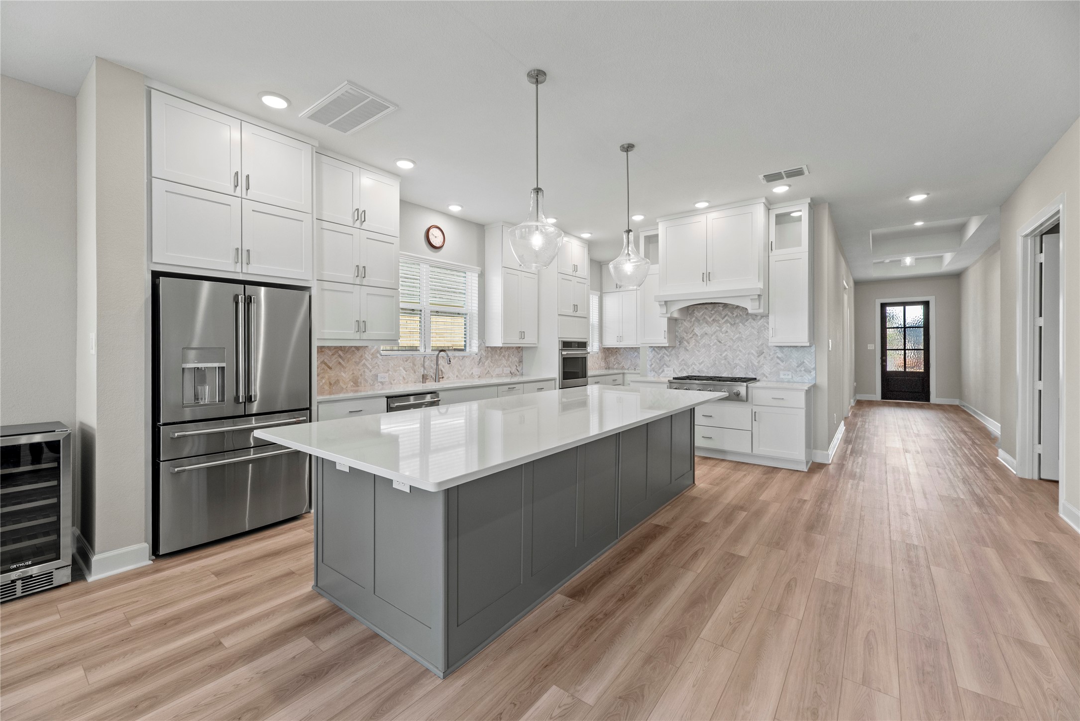 3111 Swift Way Katy, TX 77493 - Photo 23 of 50 a large kitchen with stainless steel appliances kitchen island granite countertop a large counter top a sink a refrigerator and a window