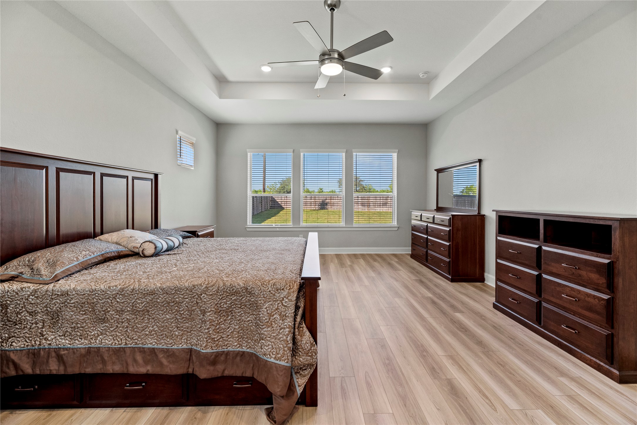 3111 Swift Way Katy, TX 77493 - Photo 37 of 50 a bedroom with a bed and dresser with wooden floor
