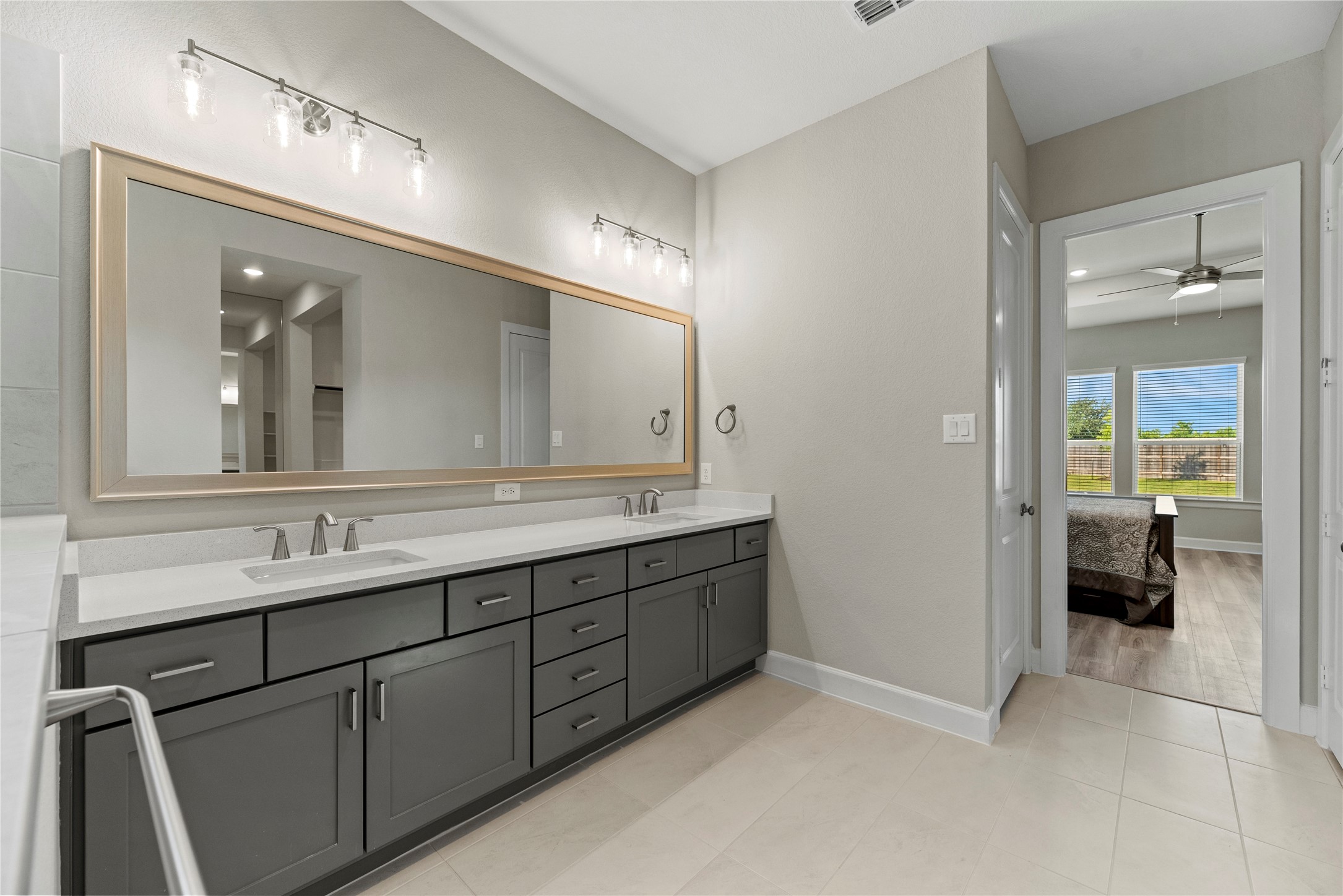 3111 Swift Way Katy, TX 77493 - Photo 40 of 50 a bathroom with a double vanity sink and a mirror