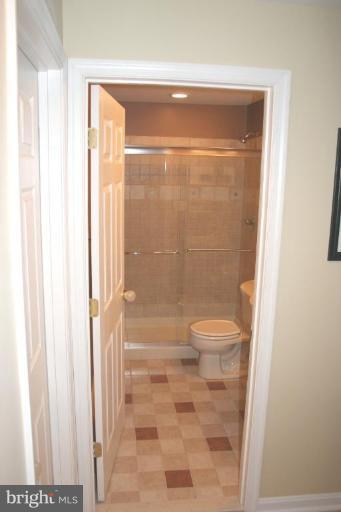 18822 Broken Oak Road Boyds, MD 20841 - Photo 22 of 28 a bathroom with a glass shower door