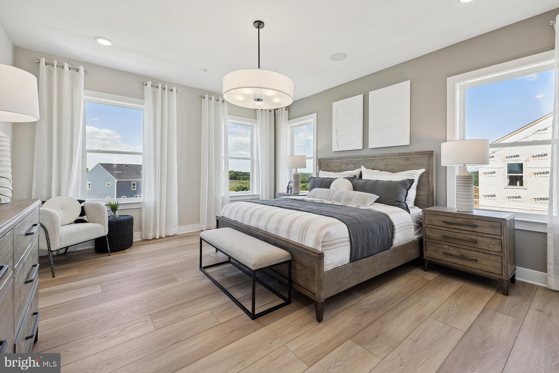 14406 Dowitcher Way, Unit 1 Boyds, MD 20841 - Photo 15 of 50 a bedroom with a bed and a chandelier