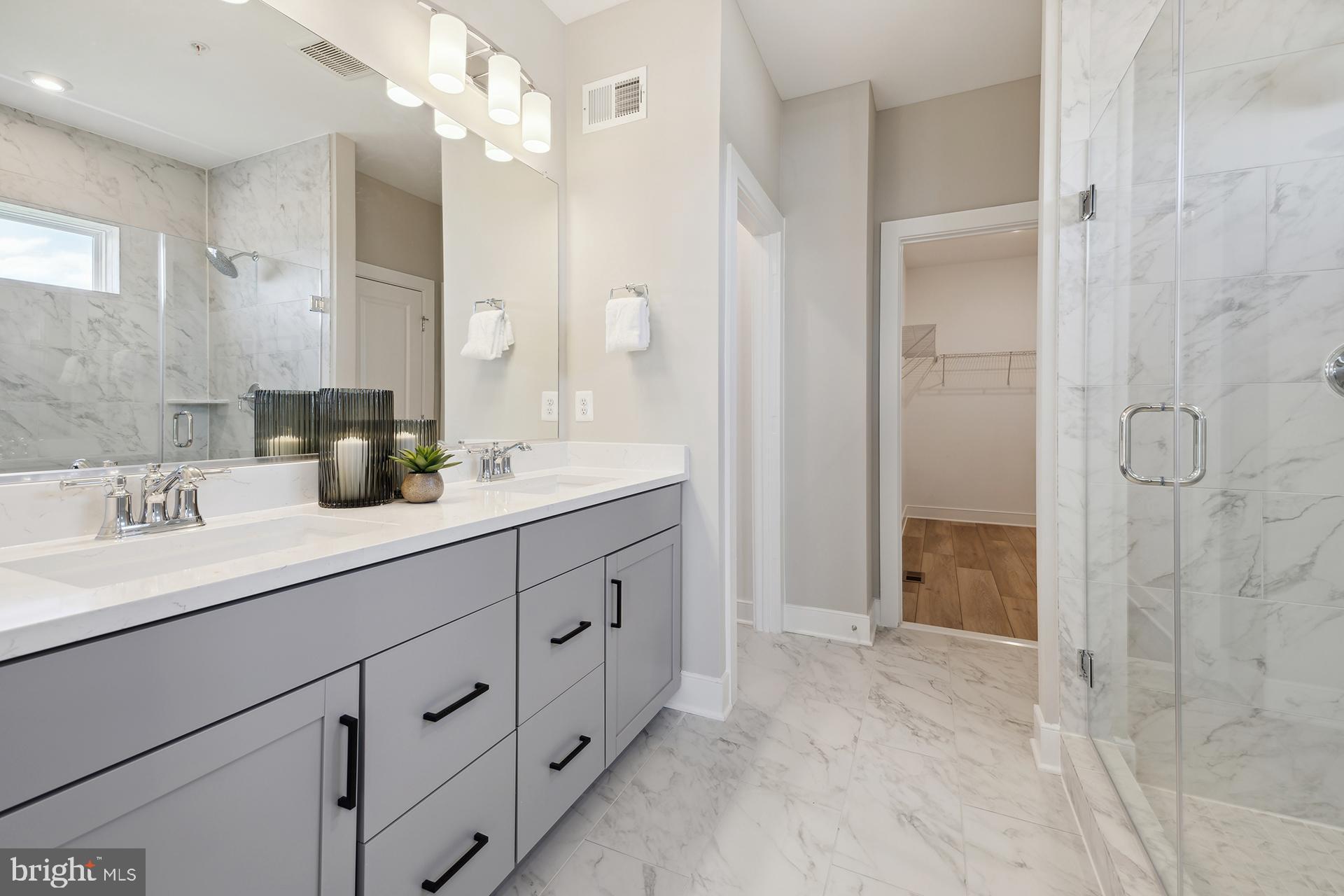 14406 Dowitcher Way, Unit 1 Boyds, MD 20841 - Photo 16 of 50 a bathroom with a double vanity sink mirror and shower