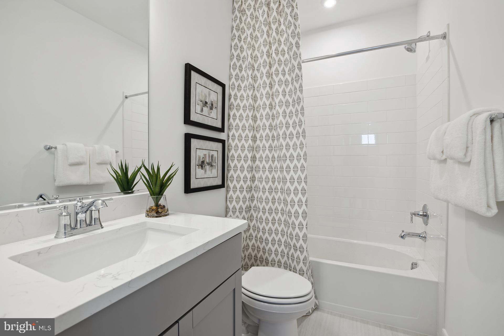 14406 Dowitcher Way, Unit 1 Boyds, MD 20841 - Photo 24 of 50 a bathroom with a sink toilet and shower