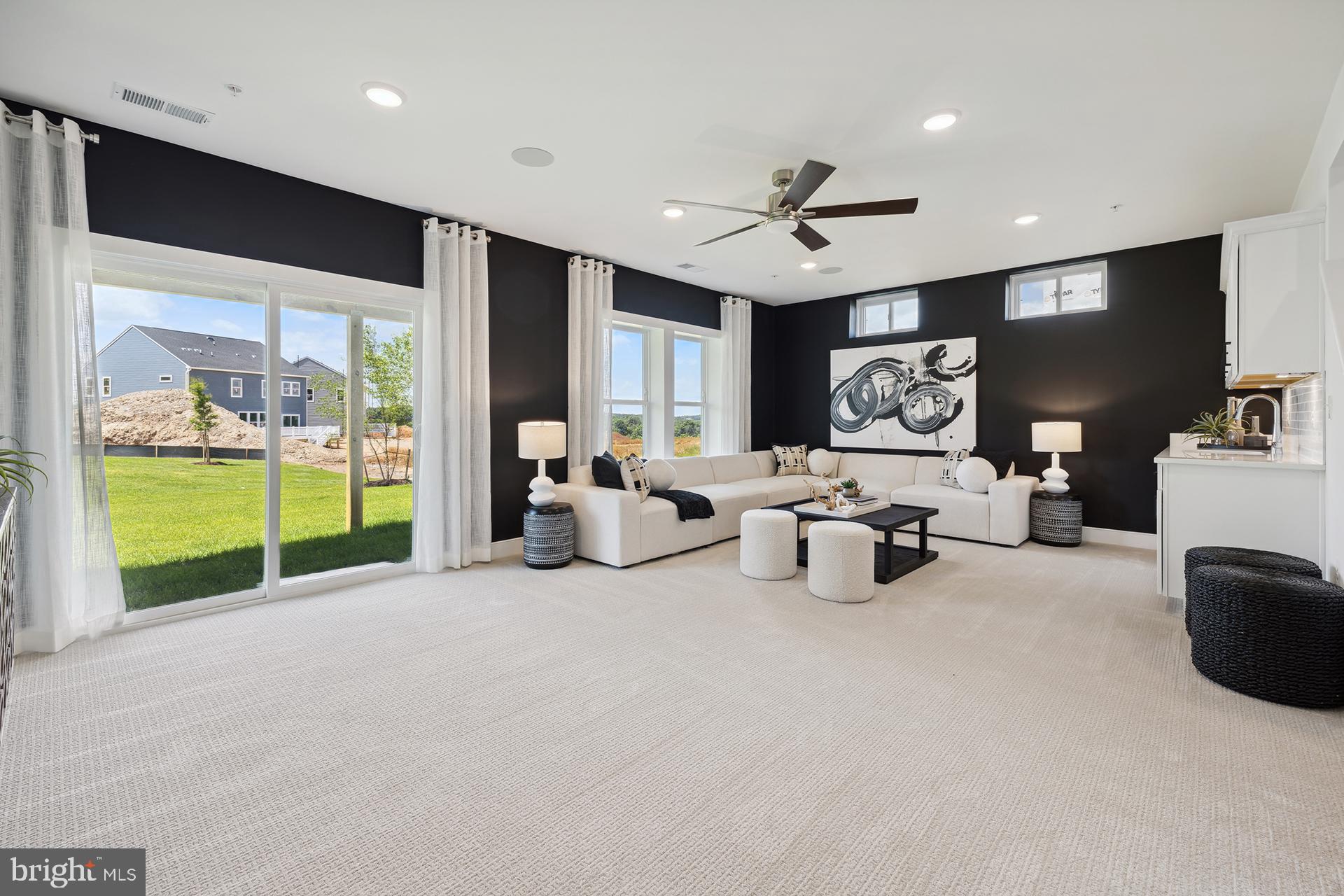 14406 Dowitcher Way, Unit 1 Boyds, MD 20841 - Photo 26 of 50 a bed room with furniture and a flat screen tv