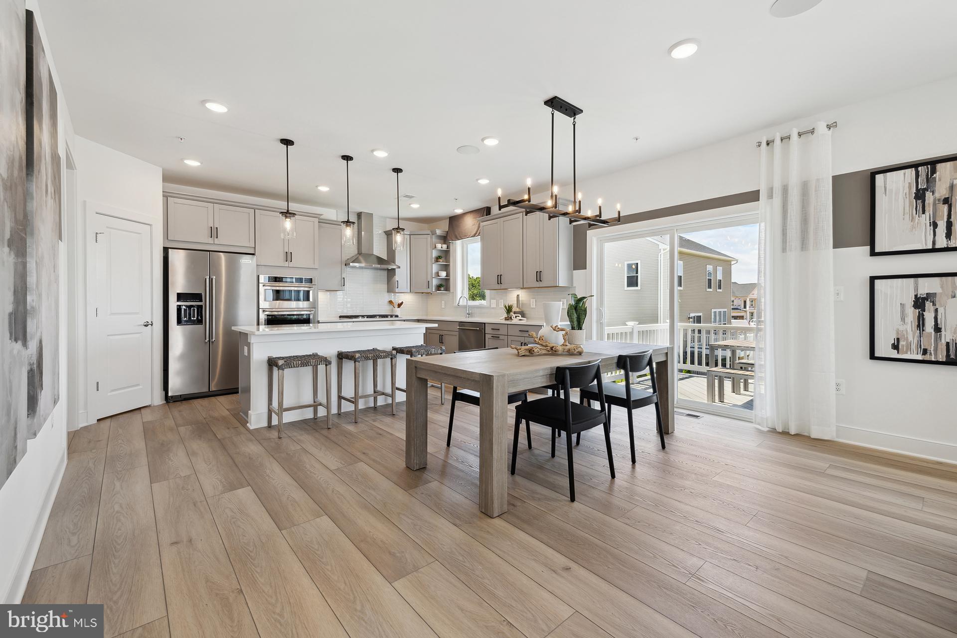14406 Dowitcher Way, Unit 1 Boyds, MD 20841 - Photo 10 of 50 a large kitchen with cabinets table and chairs