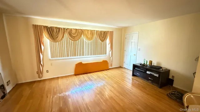 a view of an empty room and wooden floor