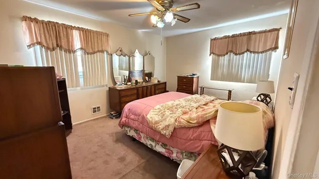 a bed room with a bed mirror and a window