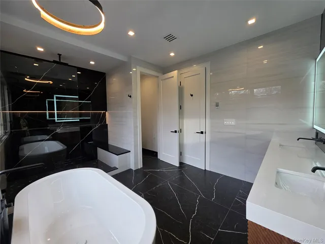 a bathroom with a sink and a large mirror