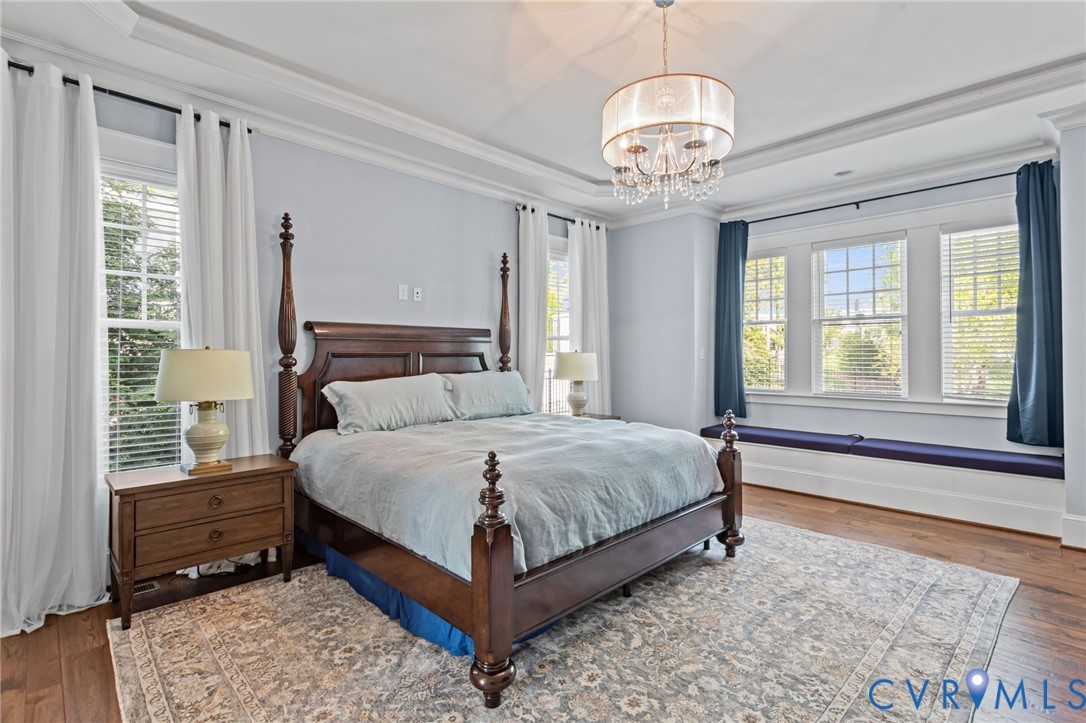 2313 Cheverton Lane Midlothian, VA 23112 - Photo 23 of 62 a bedroom with a large bed and a chandelier
