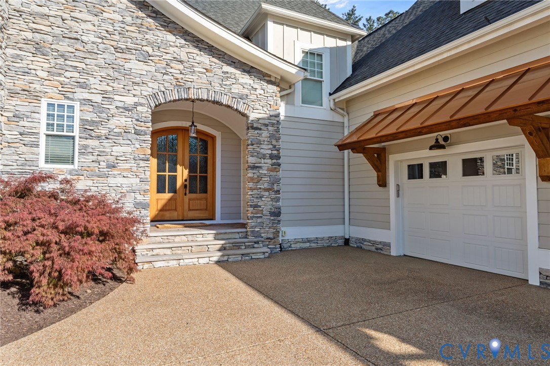 2313 Cheverton Lane Midlothian, VA 23112 - Photo 4 of 62 a front view of a house with a garage