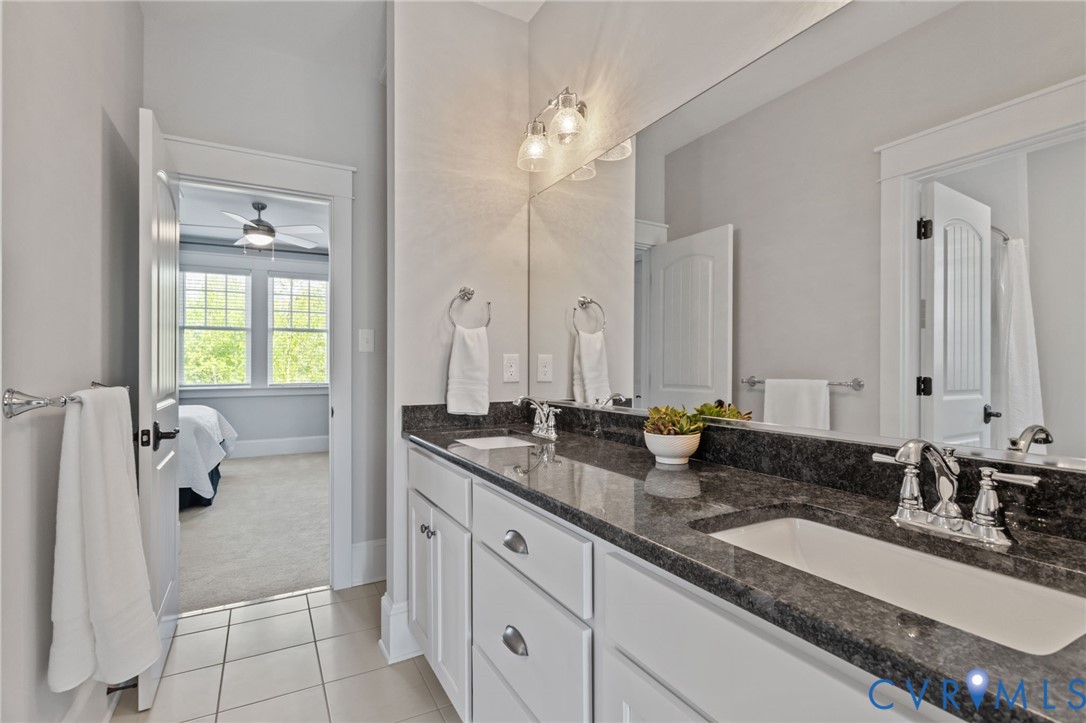 2313 Cheverton Lane Midlothian, VA 23112 - Photo 42 of 62 a bathroom with a granite countertop sink and a mirror