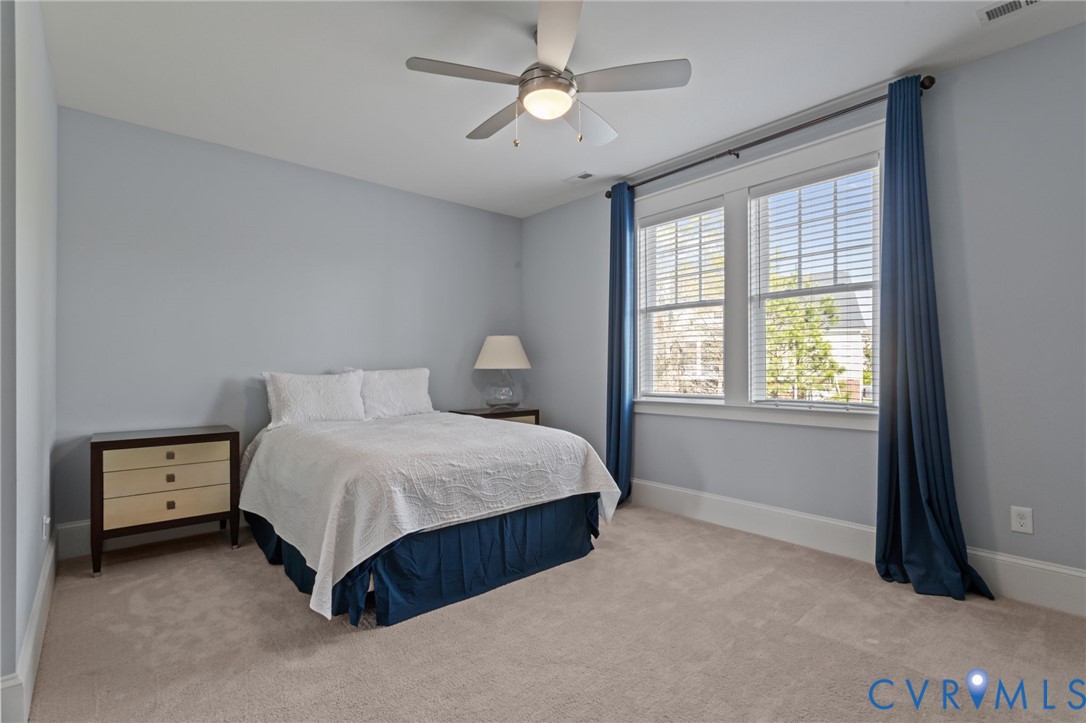 2313 Cheverton Lane Midlothian, VA 23112 - Photo 45 of 62 a spacious bedroom with a bed and a chandelier
