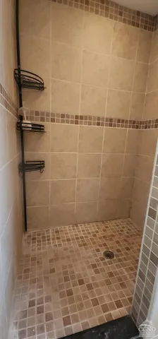 a bathroom with a toilet a sink a window and mirror