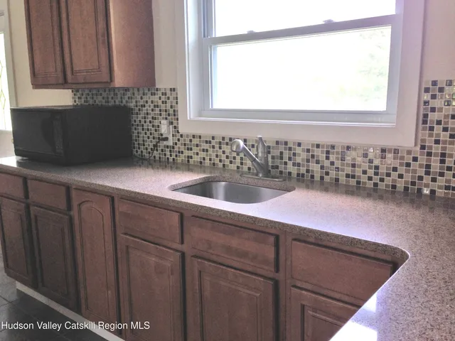 a view of a house with a snow in the yard