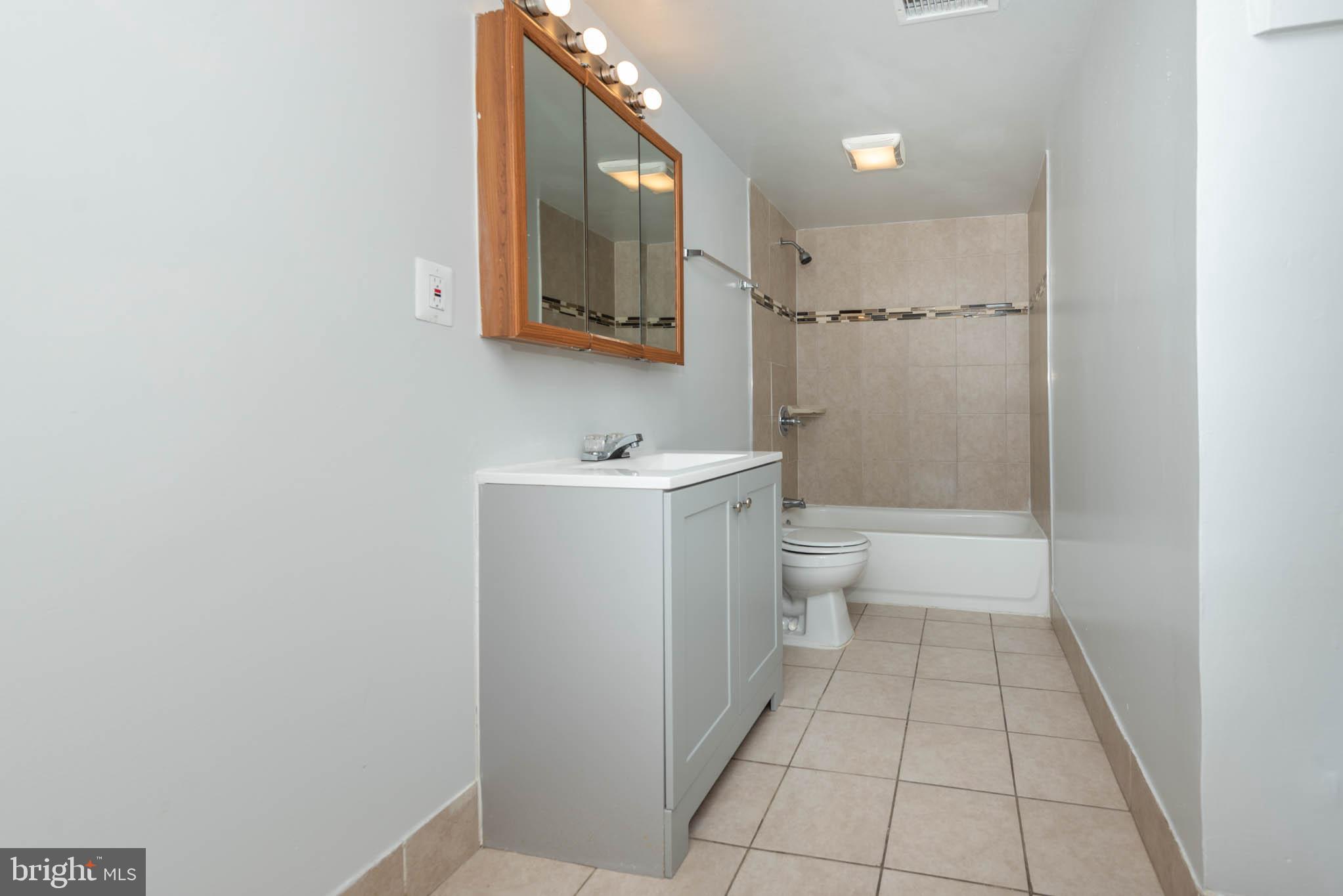 1911 West Baltimore Street Baltimore, MD 21223 - Photo 11 of 32 a bathroom with a sink a toilet and a mirror