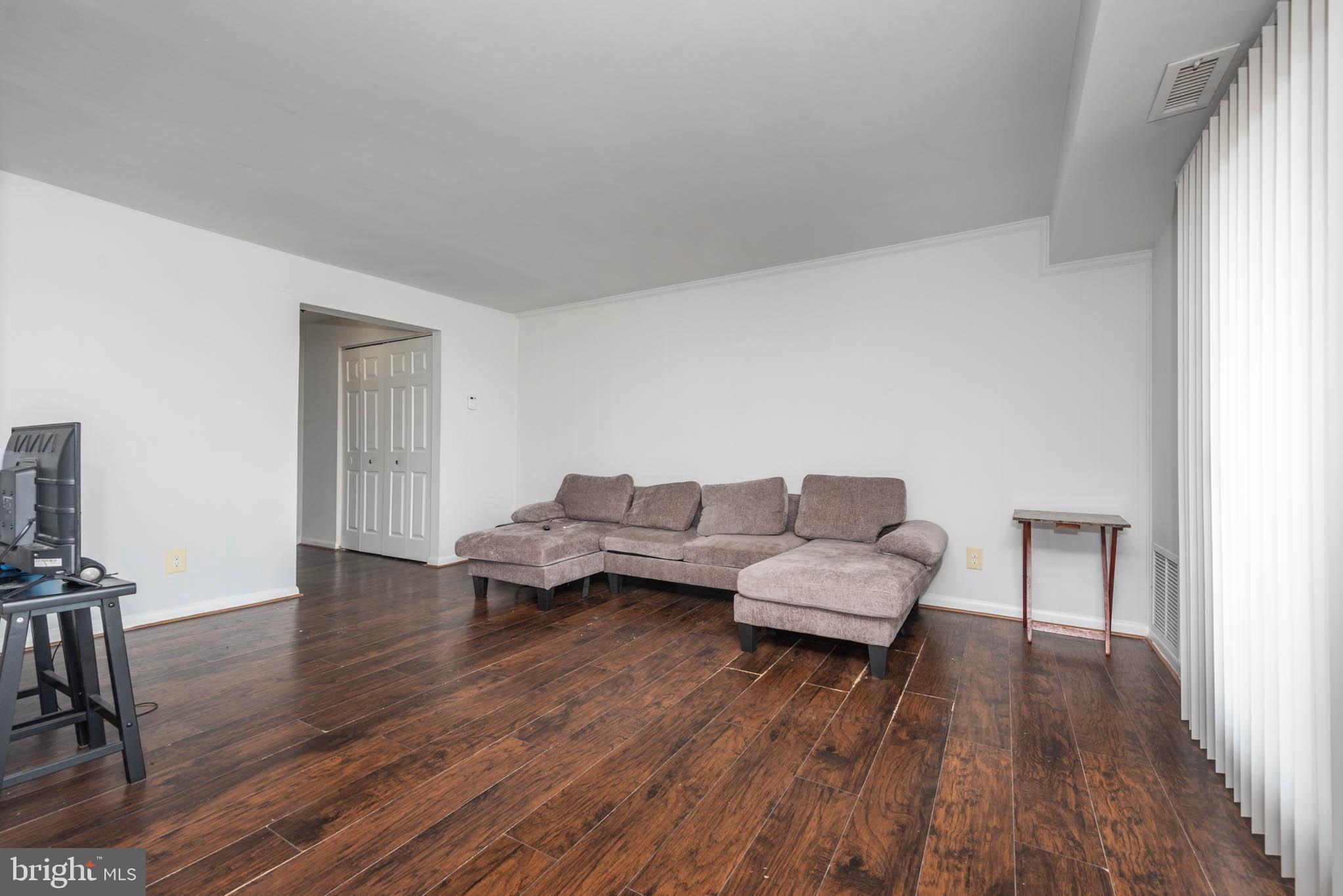 1911 West Baltimore Street Baltimore, MD 21223 - Photo 15 of 32 a living room with furniture and a wooden floor