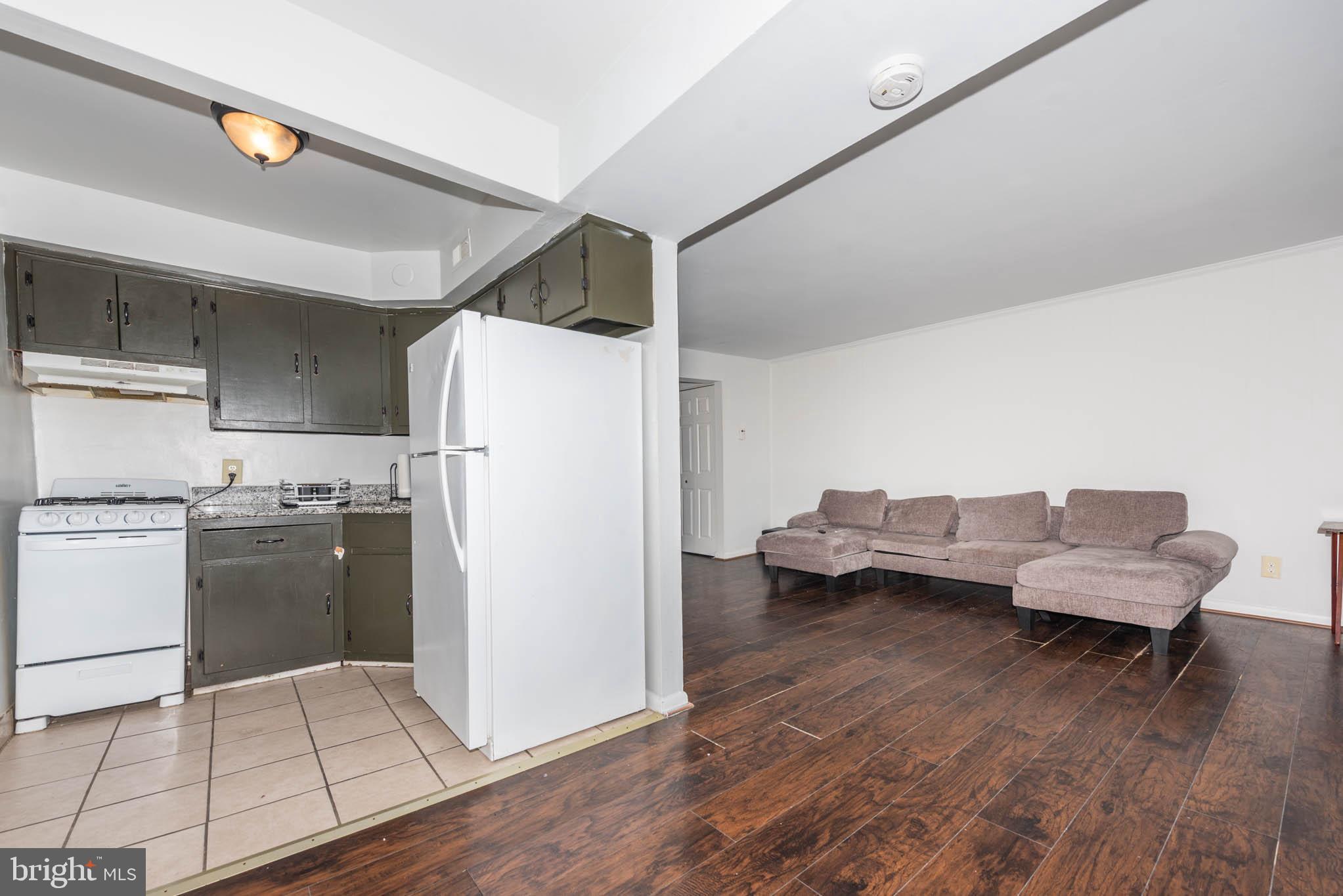 1911 West Baltimore Street Baltimore, MD 21223 - Photo 16 of 32 a kitchen with a refrigerator and a stove top oven