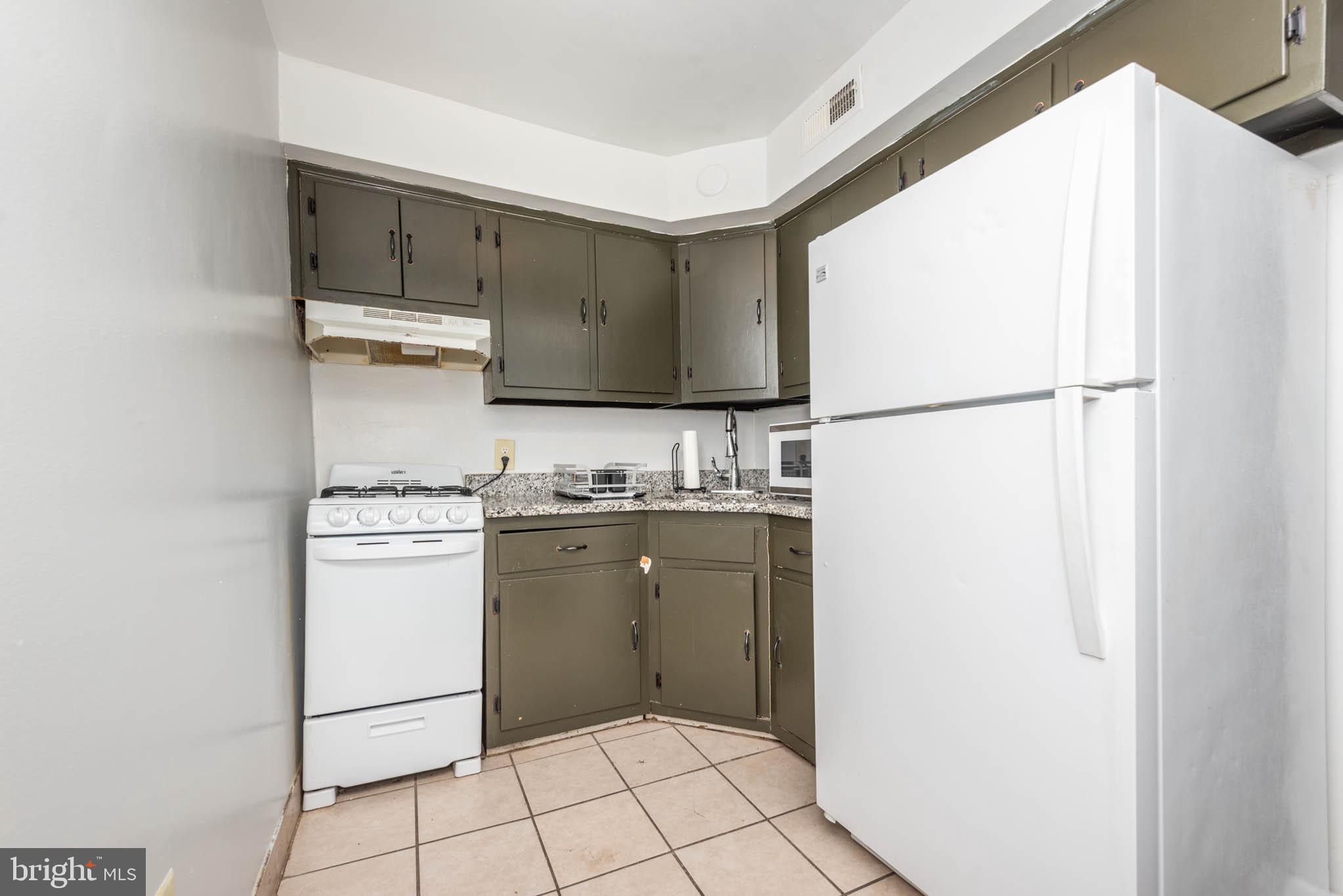 1911 West Baltimore Street Baltimore, MD 21223 - Photo 17 of 32 a room with a refrigerator and a stove