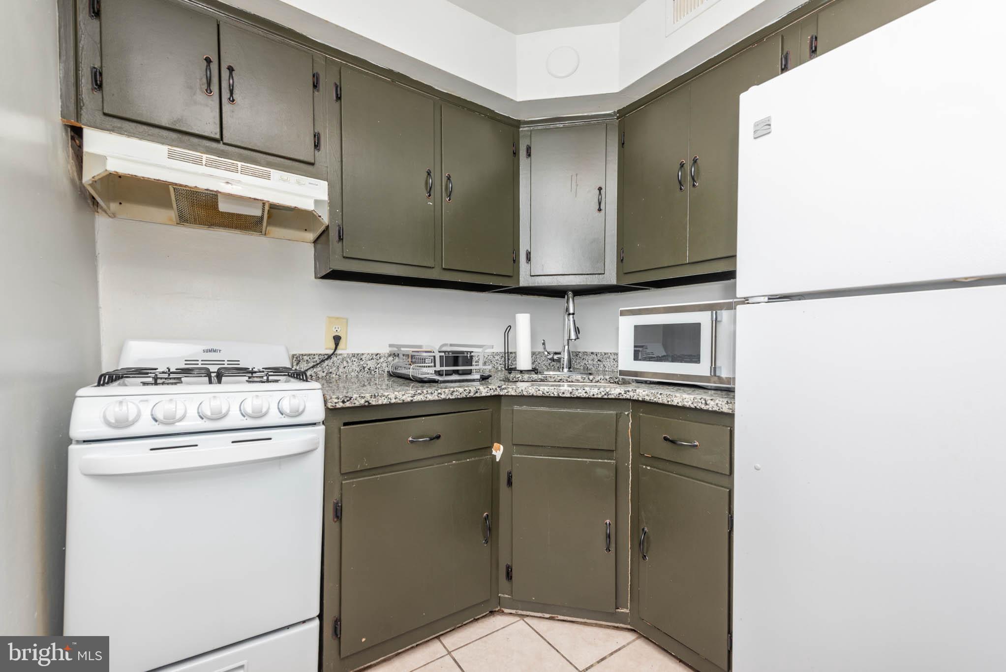 1911 West Baltimore Street Baltimore, MD 21223 - Photo 18 of 32 a kitchen with a stove top oven sink and cabinets