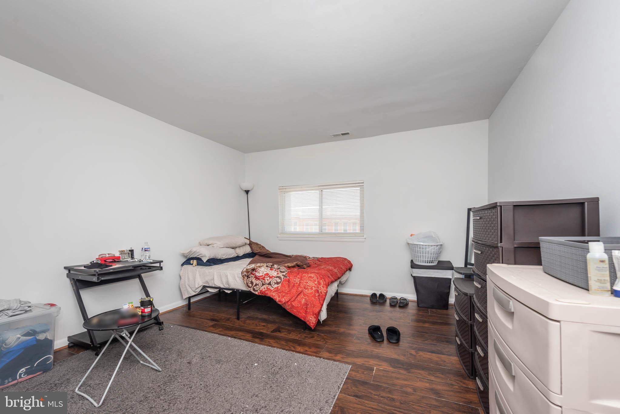 1911 West Baltimore Street Baltimore, MD 21223 - Photo 19 of 32 a bedroom with a bed and wooden floor