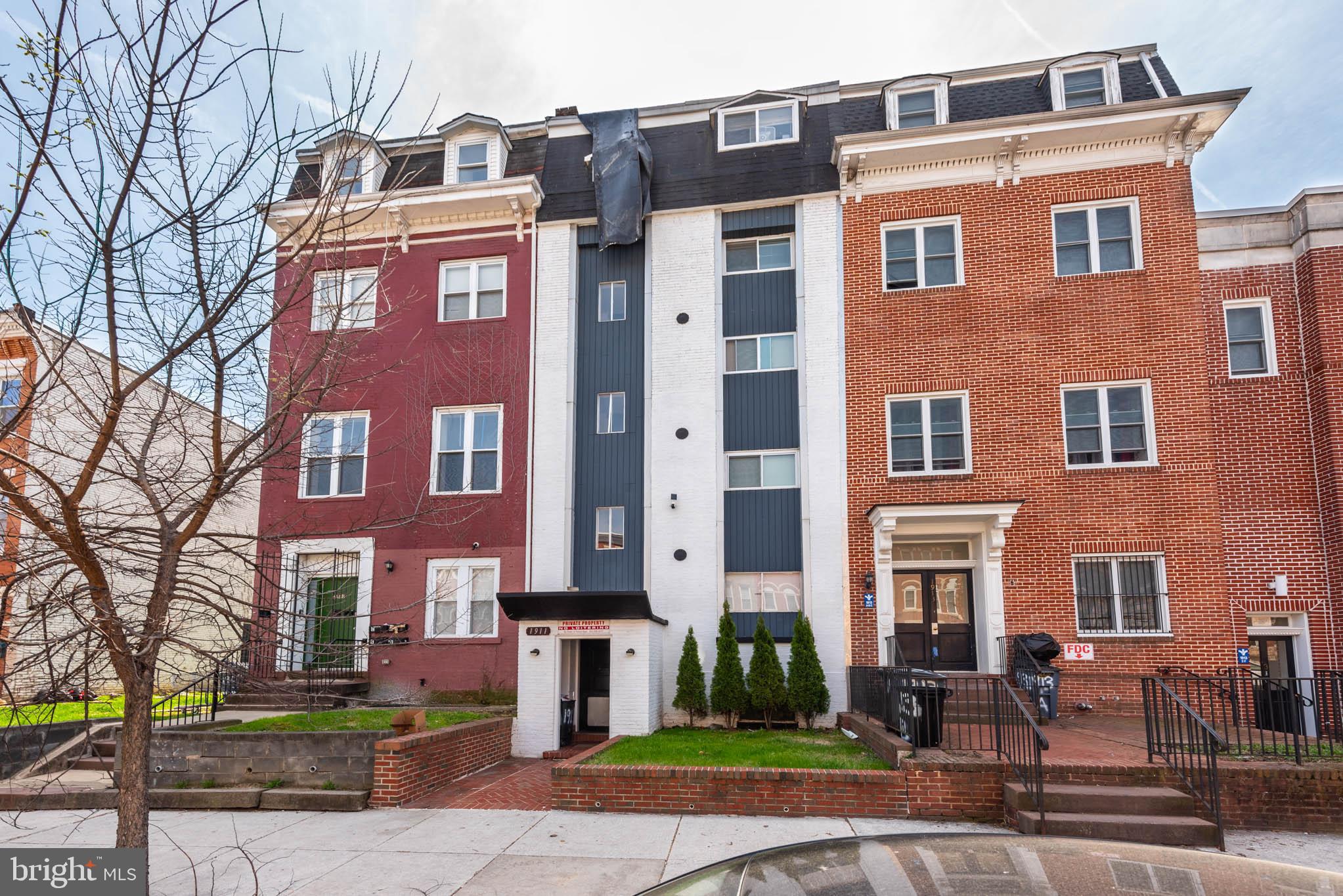 1911 West Baltimore Street Baltimore, MD 21223 - Photo 30 of 32 a front view of a building with garden and trees