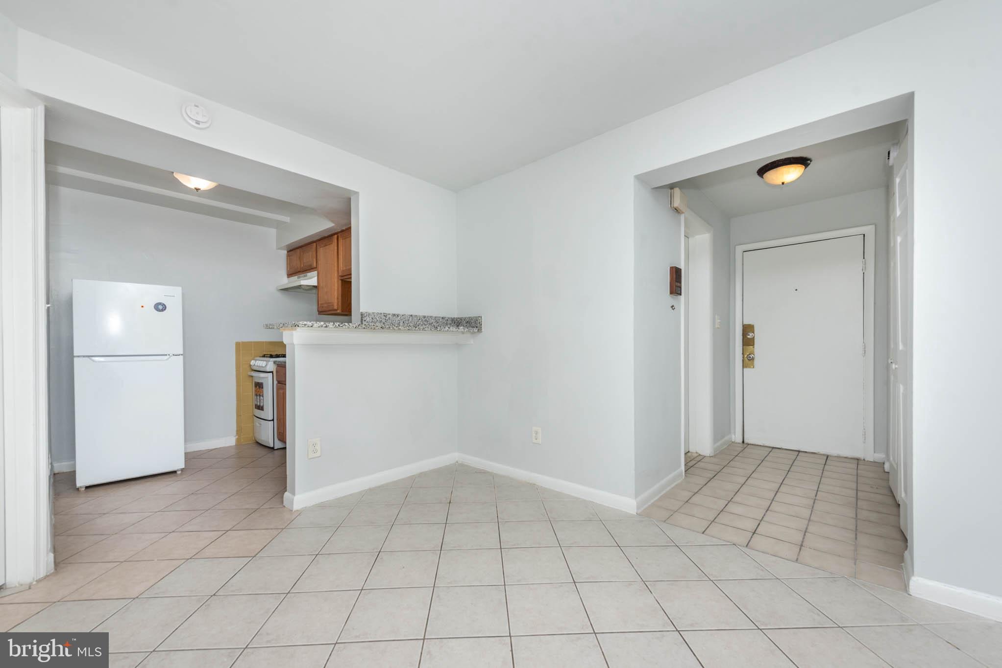 1911 West Baltimore Street Baltimore, MD 21223 - Photo 4 of 32 a view of a kitchen with white cabinets and refrigerator