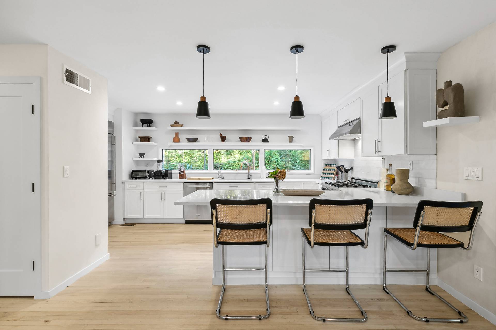 5 Jasons Lane East Hampton, NY 11937 - Photo 4 of 12 a kitchen with stainless steel appliances kitchen island granite countertop a stove a sink and white cabinets with wooden floor